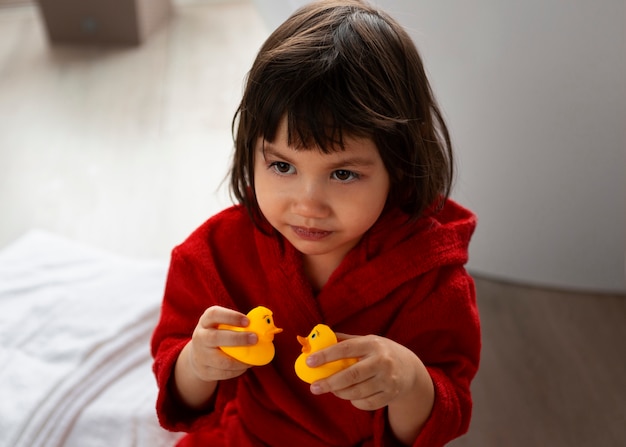 Free photo high angle girl wearing bathrobe