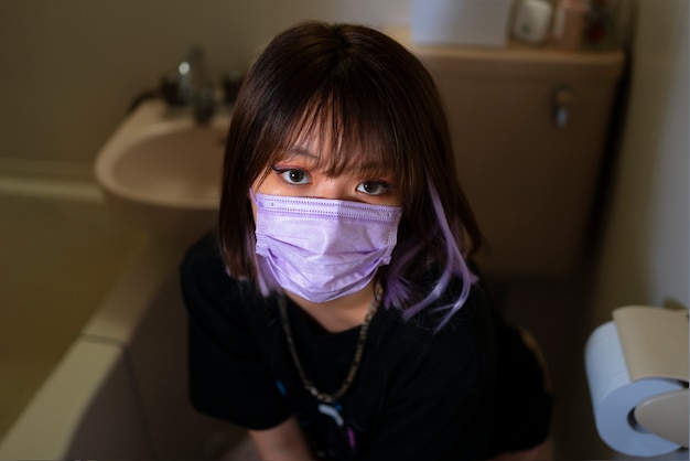 Free photo high angle girl wearing purple mask