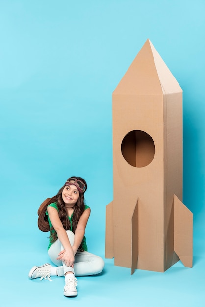 High angle girl with cartoon airplane toy