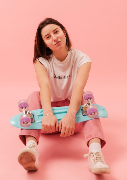 Free photo high angle girl with skateboard