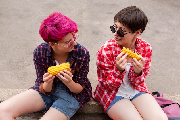 High angle girls eating corn together