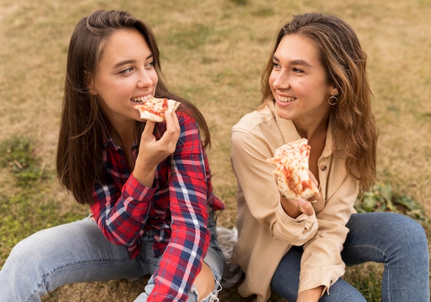 High angle girls eating pizza