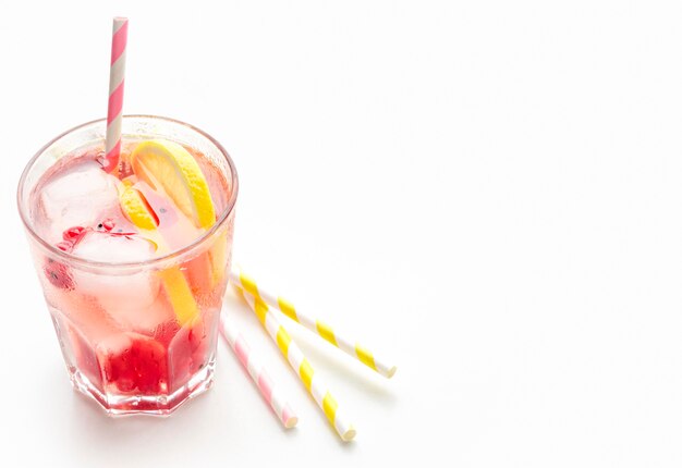 High angle glass of cranberry vodka with lemon and ice with copy-space