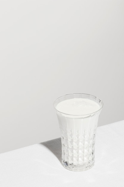 Free photo high angle of glass of milk with copy space