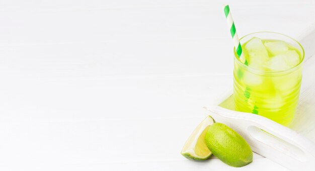 High angle of glass of soft drink with lime and copy space