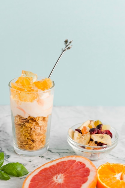 High angle glass with cornflakes with yogurt and fruits
