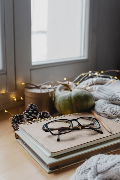 Free photo high angle glasses on agendas with blanket and lights