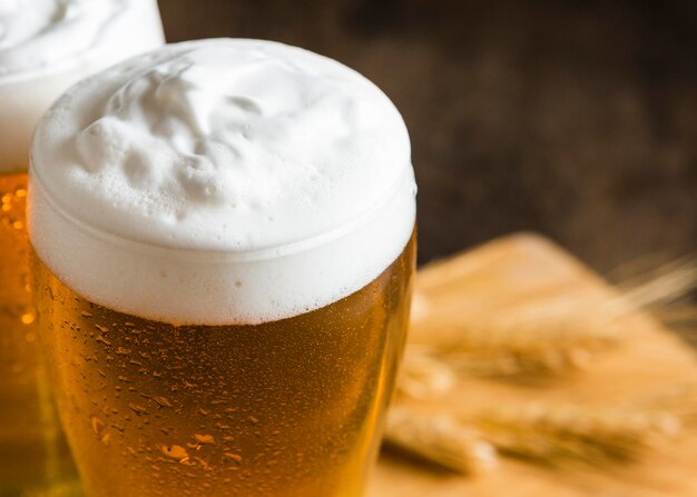 High angle of glasses of beer with foam