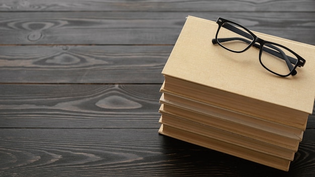 High angle glasses on books stack