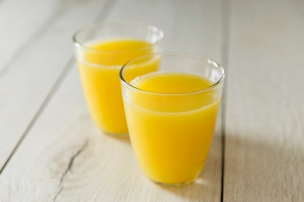 High angle of glasses of orange juice