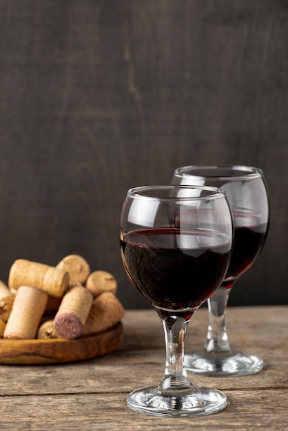 High angle glasses with red wine on table