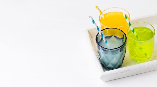 High angle of glasses with soft drinks and copy space