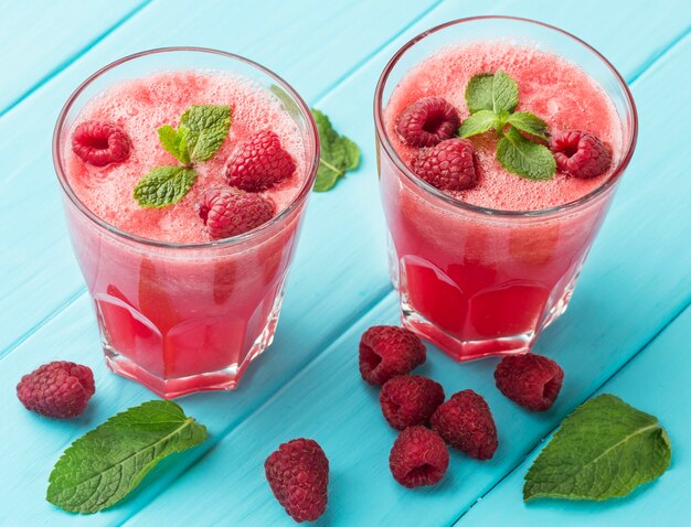 High angle of glasses with watermelon cocktails and mint