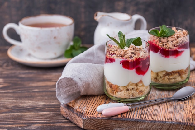 High angle of glasses with yogurt and cereal