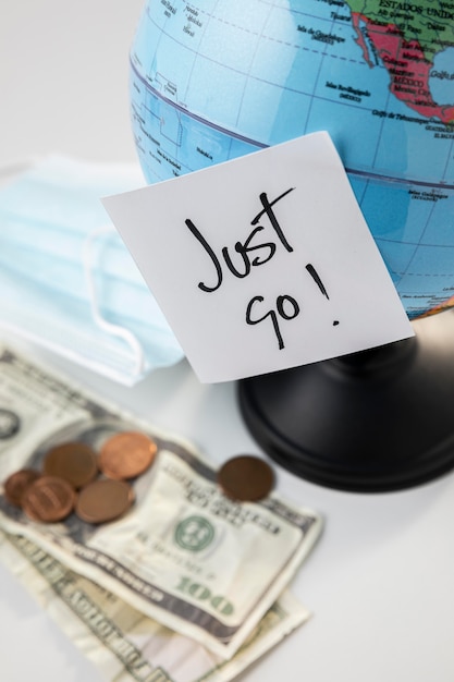 Free photo high angle of globe with banknotes and sticky note