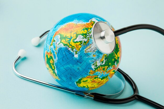 High angle of globe with stethoscope for peace day