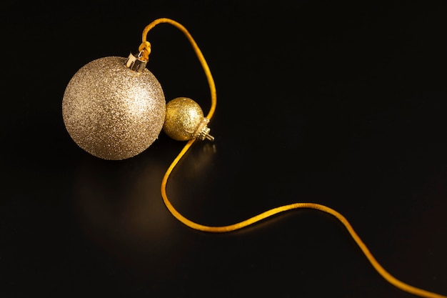 Free photo high angle of golden christmas globe with string