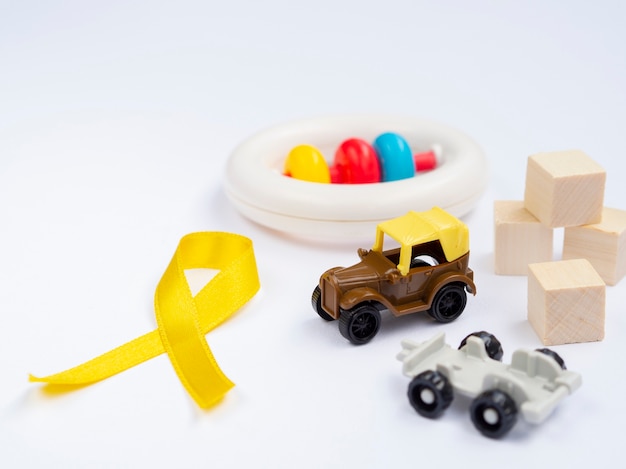 Free photo high angle golden ribbon with toys arrangement