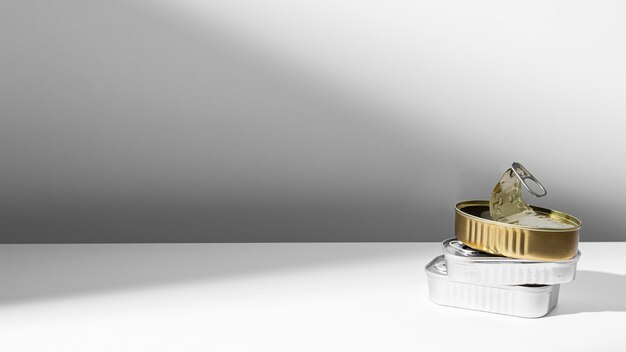 High angle golden and silver tin cans with copy-space
