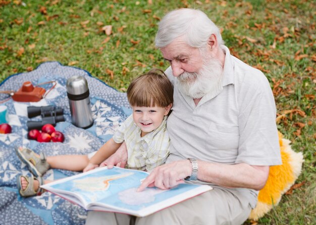 High angle grandpa reading for grandson