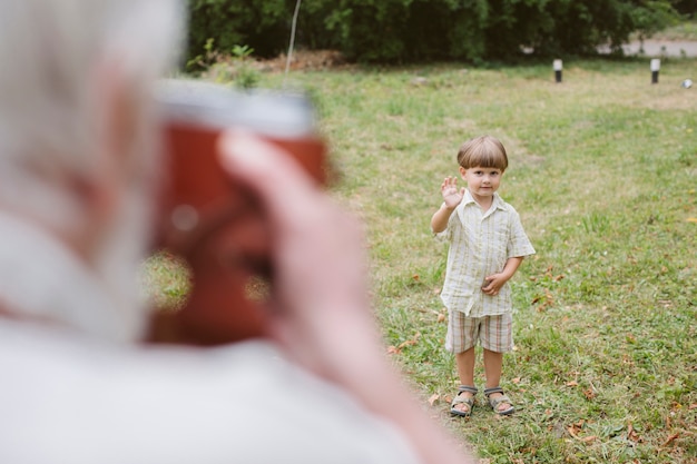 Free photo high angle grandpa taking photo of grandson