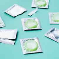 Free photo high angle green condoms on green background