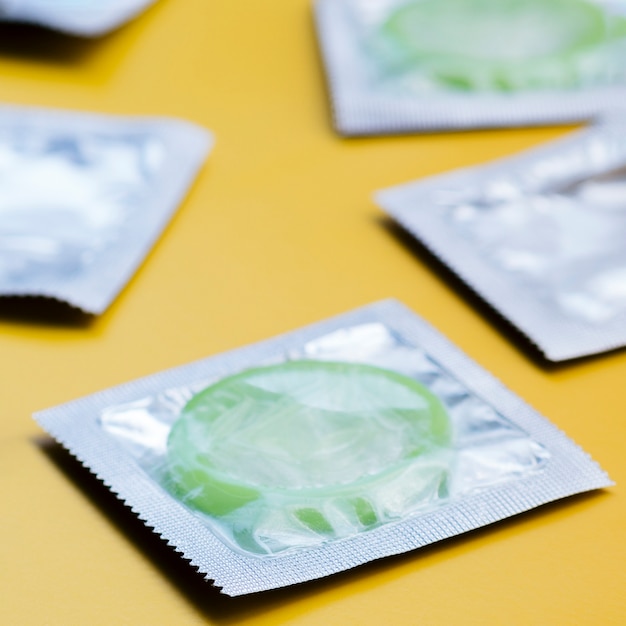 Free photo high angle green condoms in wrappers