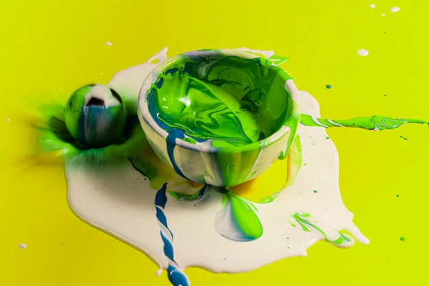 Free photo high angle green paint with yellow background