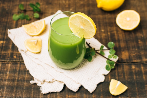 High angle green smoothie with lemons