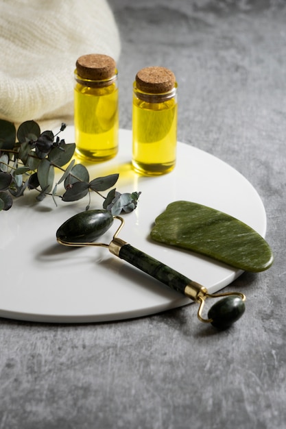 Free photo high angle gua sha and face roller arrangement