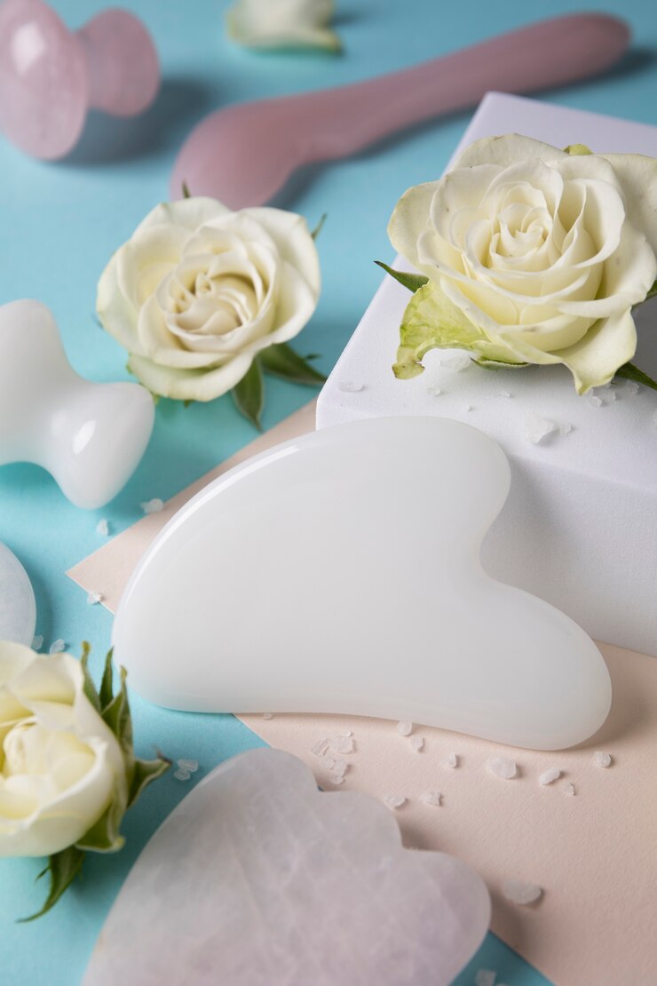 Free Photo high angle gua sha and flowers arrangement