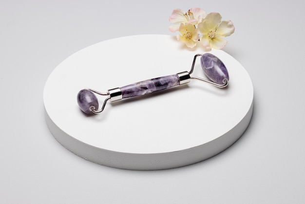 Free photo high angle gua sha tool and flower