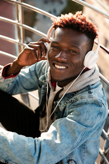 High angle guy with headphones posing