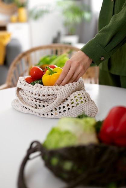 Free photo high angle hand holding bell pepper