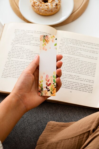 High angle hand holding bookmark