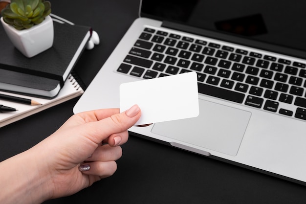 High angle of hand holding business card