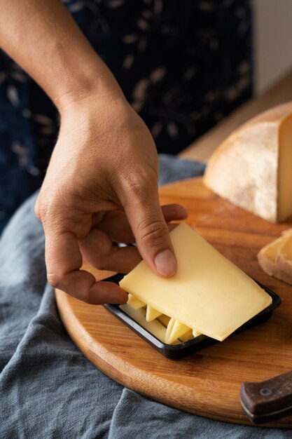 High angle hand holding cheese slice