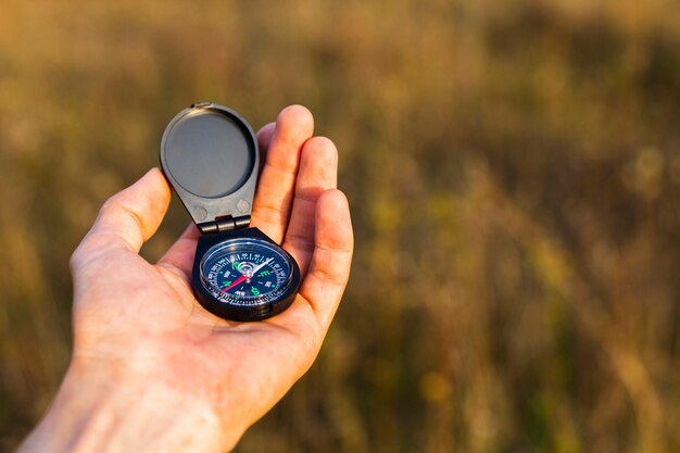 High angle hand holding compass