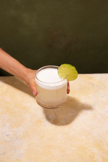 High angle hand holding daiquiri cocktail