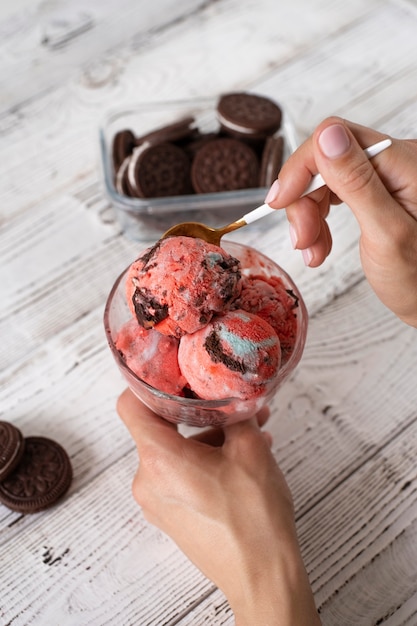 Free photo high angle hand holding ice cream cup