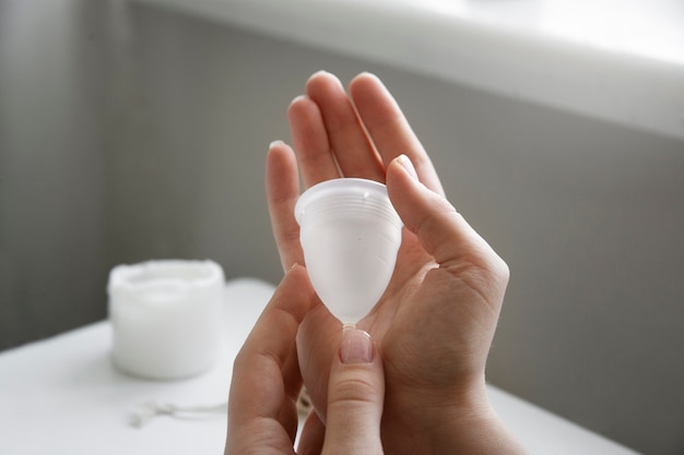 High angle hand holding menstrual cup