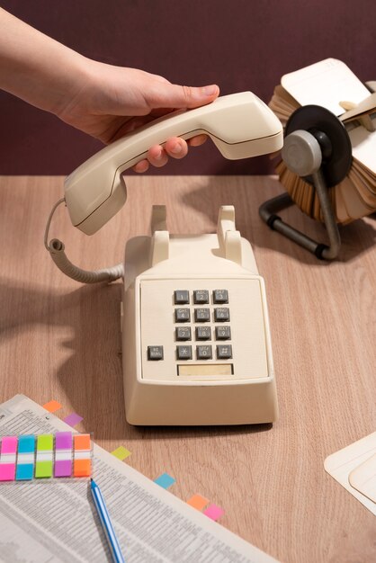 High angle hand holding old telephone