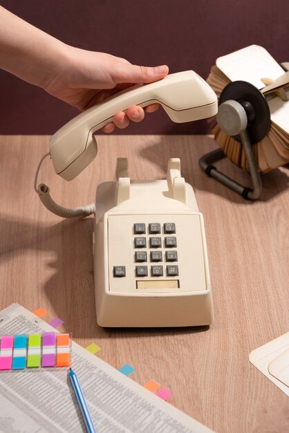 high angle hand holding old telephone