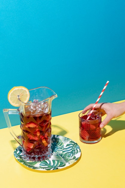 Free photo high angle hand holding sangria drink