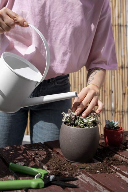 High angle hand holding watering can