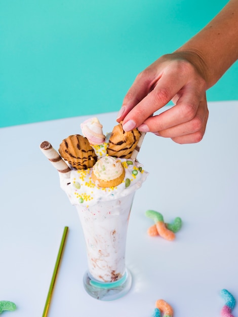 Free photo high angle of hand and milkshake