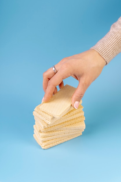 Free photo high angle of hand on top of stacked wafers