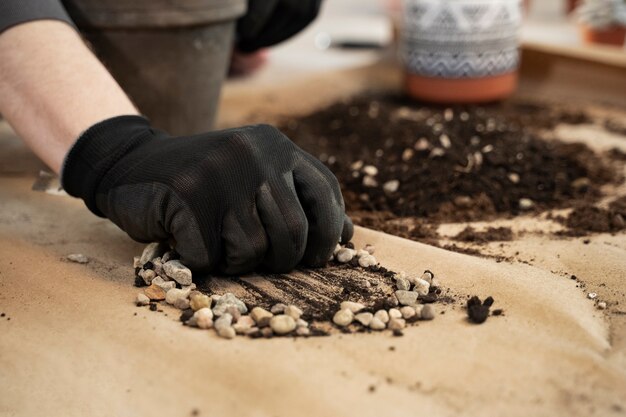 High angle hand with glove holding pebbles