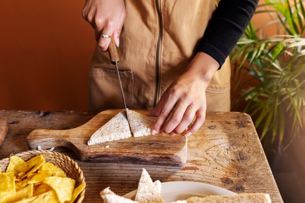 High angle hands cutting bread