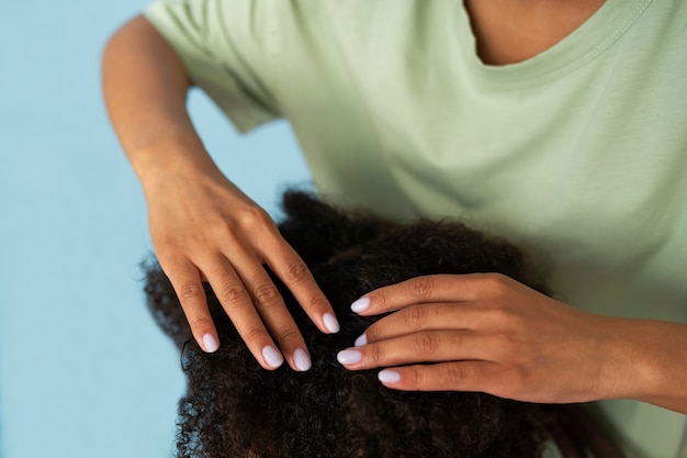 Free photo high angle hands helping kid with lice